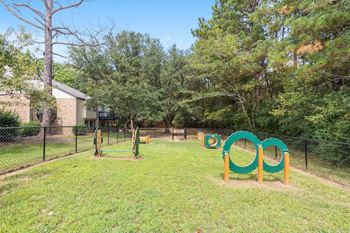 A playground with a green and yellow slide.